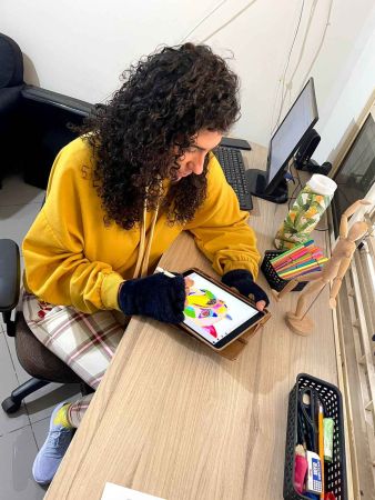 xRainbow Rafa Beleze drawing on an iPad.